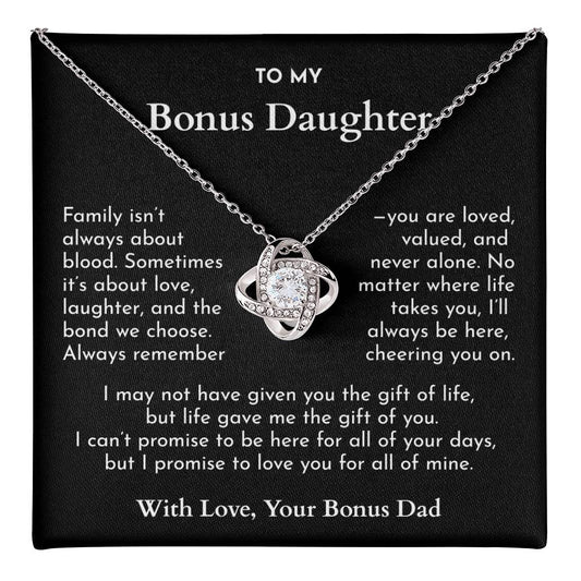 Necklace with a heart-shaped pendant on a card addressed to a bonus daughter from a bonus dad.
