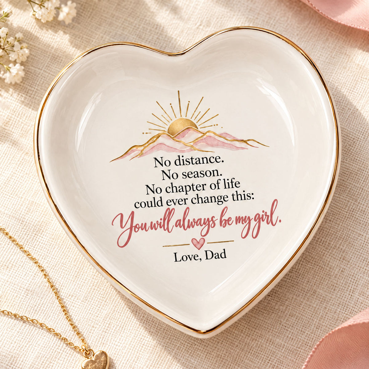 Heart-shaped white jewelry dish with gold trim and an Always My Girl message from Dad, displayed on soft ivory fabric.
 Copy alt text