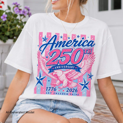 Pink America 250th Anniversary shirt with patriotic eagle graphic, stars, and vintage-inspired 1776-2026 artwork displayed in a summer flat lay with denim shorts.