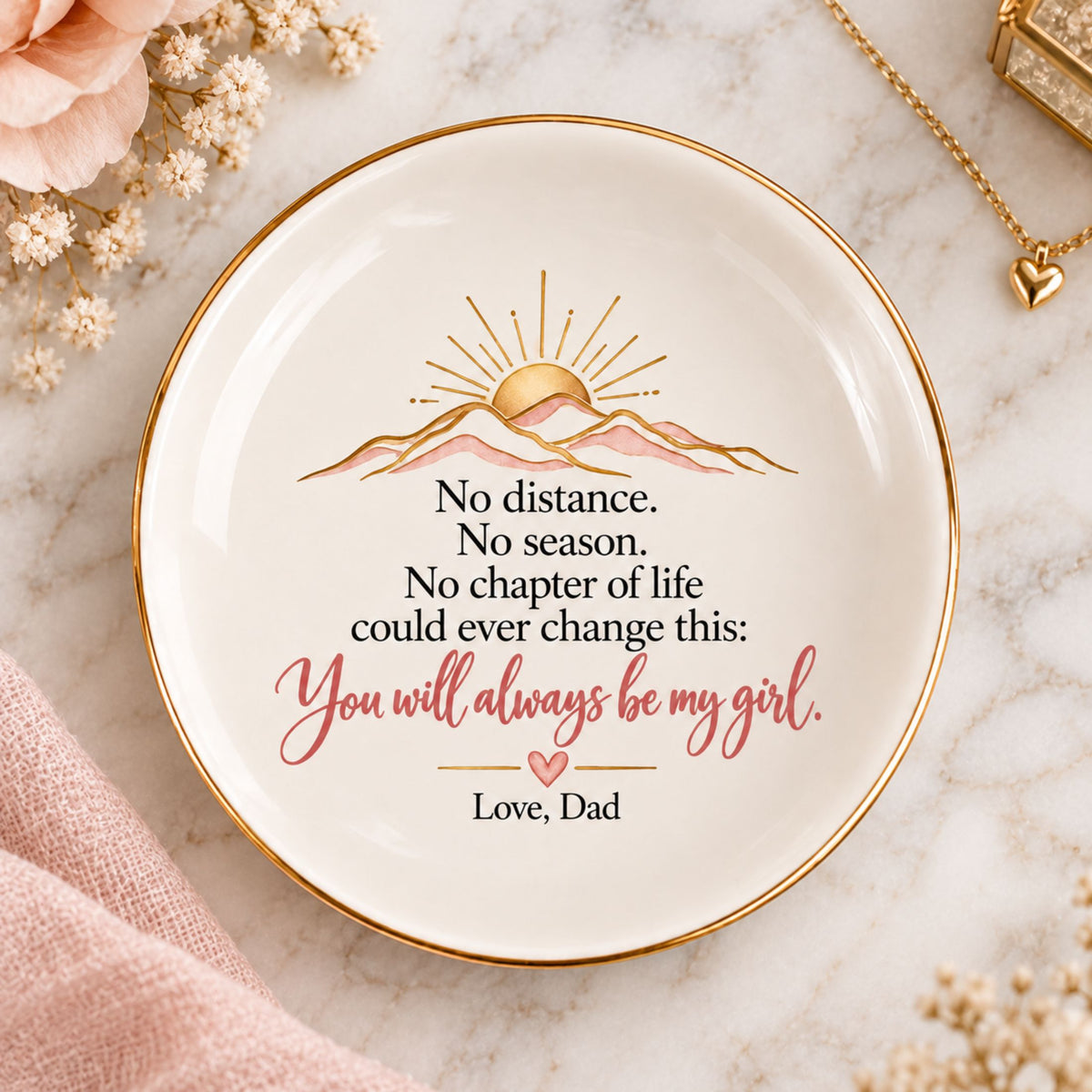 Round white ceramic trinket dish with gold rim, blush and gold sunrise illustration, and a loving message from Dad to daughter.
 Copy alt text