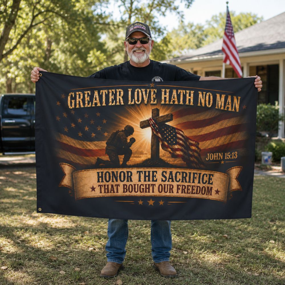 Proud veteran holding Greater Love Hath No Man Christian patriotic flag outdoors