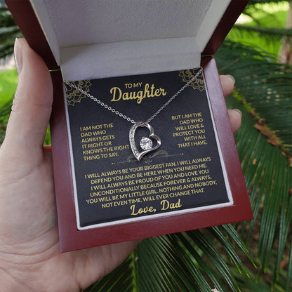 Emotional silver daughter necklace gift presented in red box with heartfelt message card, held outdoors for a natural, real-life feel